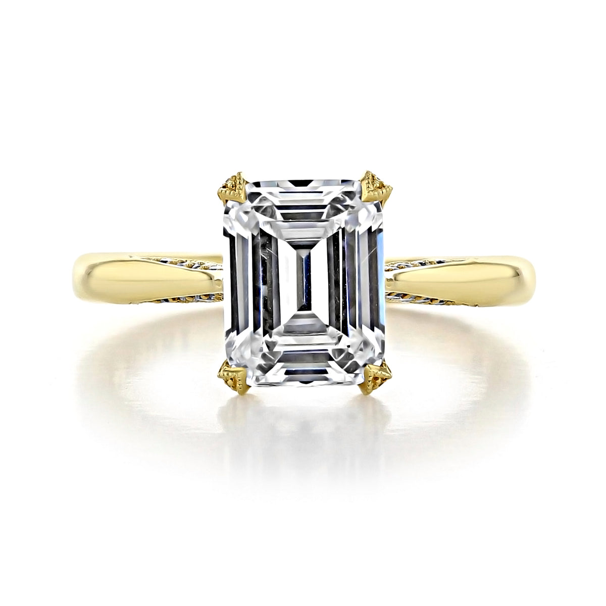 Tacori Royal T Emerald Solitaire Engagement Ring - HT2625EC9X7Y featuring an emerald-cut diamond in a four-prong setting on a yellow gold band.