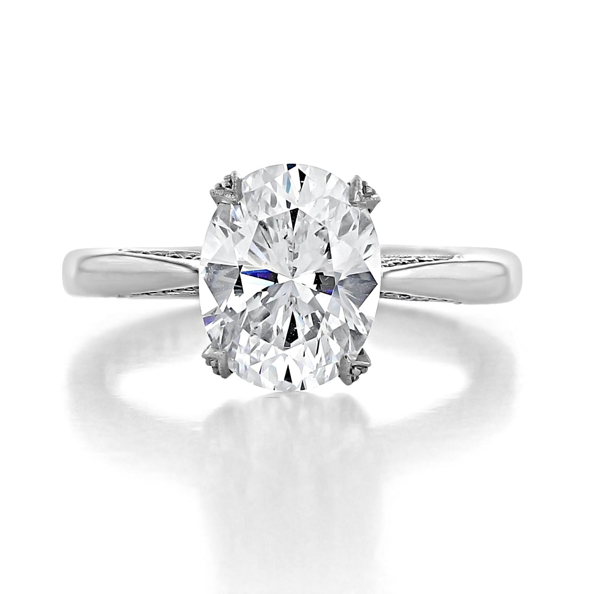 Tacori RoyalT HT2625OV10X8W oval solitaire diamond ring set in a polished metal band with intricate side detailing.