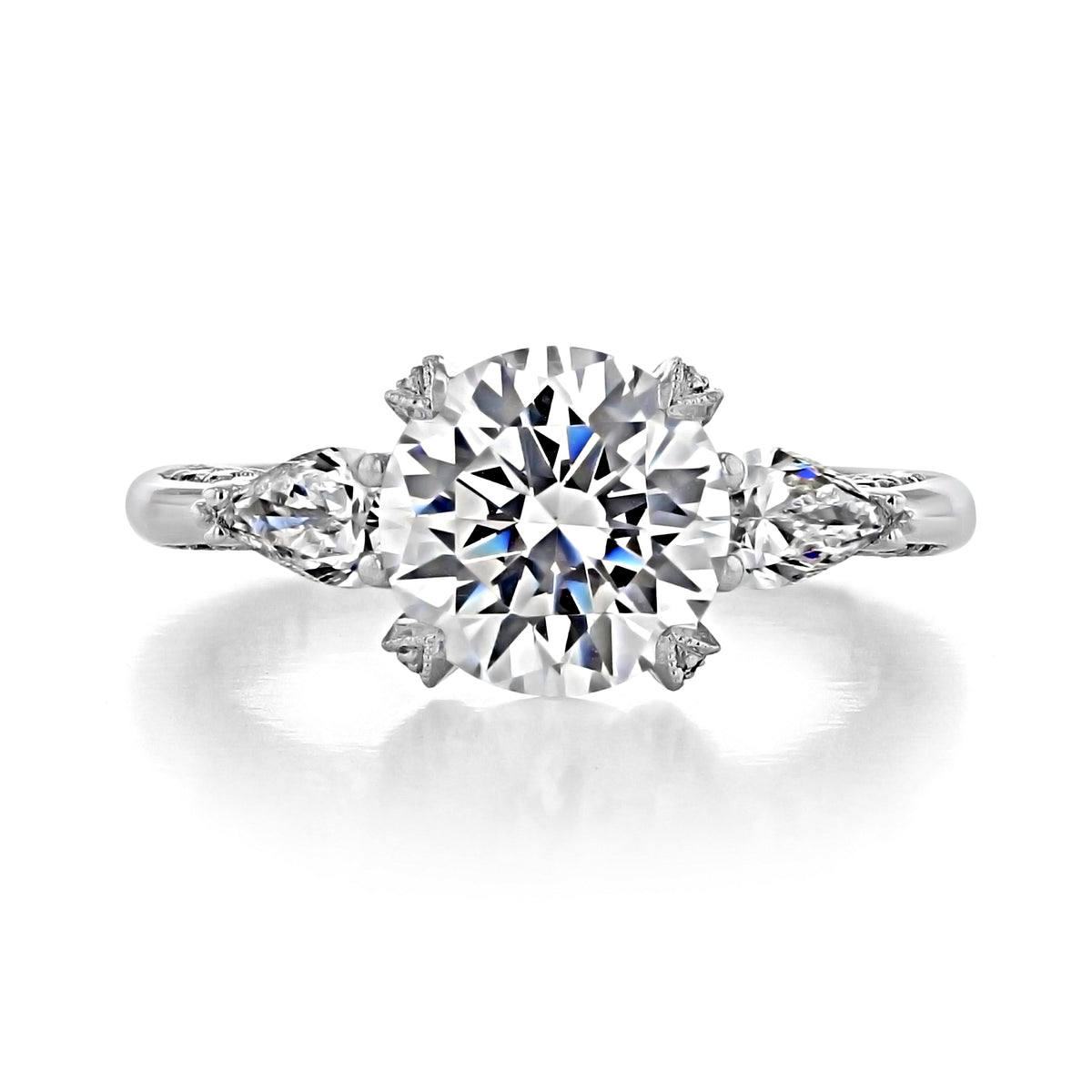 Tacori Royal T | Round Solitaire Engagement Ring - HT2628RD85W featuring a round center diamond flanked by two pear-shaped diamonds on a silver-toned band.