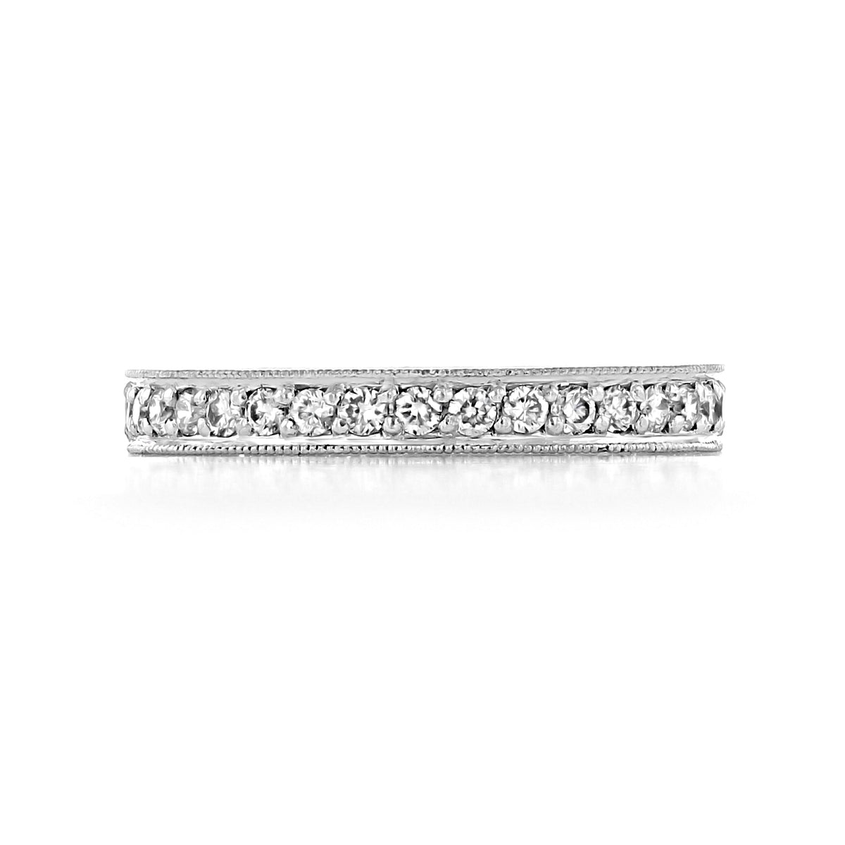 The Sabina 2.70mm Engraved Pavé-Set Diamond Wedding Band in 18k white gold features a row of pavé-set diamonds bordered by engraved milgrain edges.