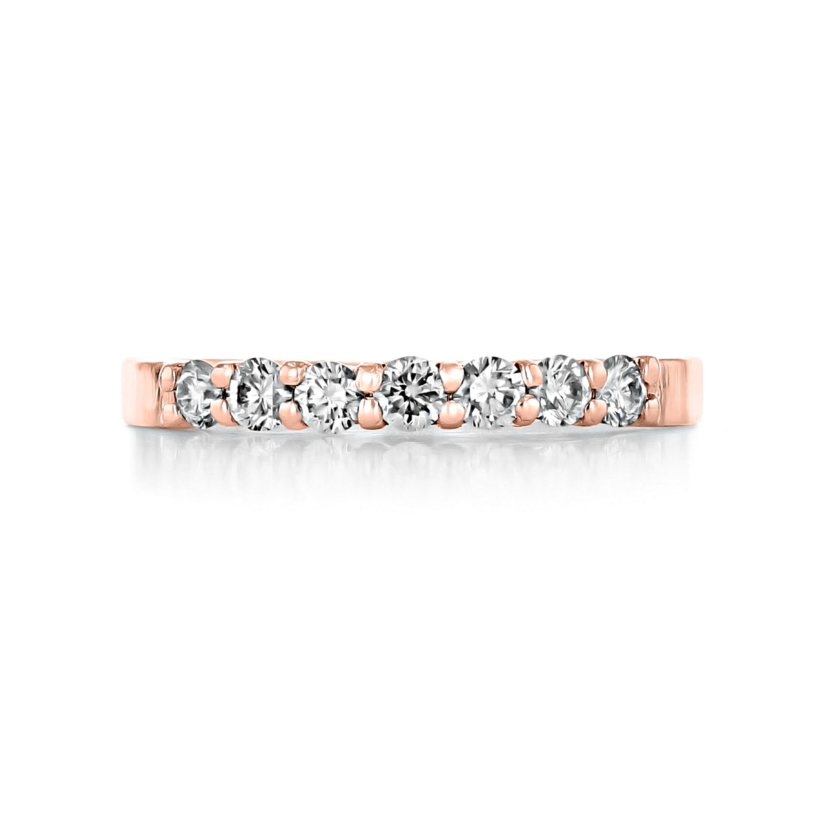 Marabel prong-set diamond wedding band in 14k rose gold featuring seven round diamonds in prong settings.