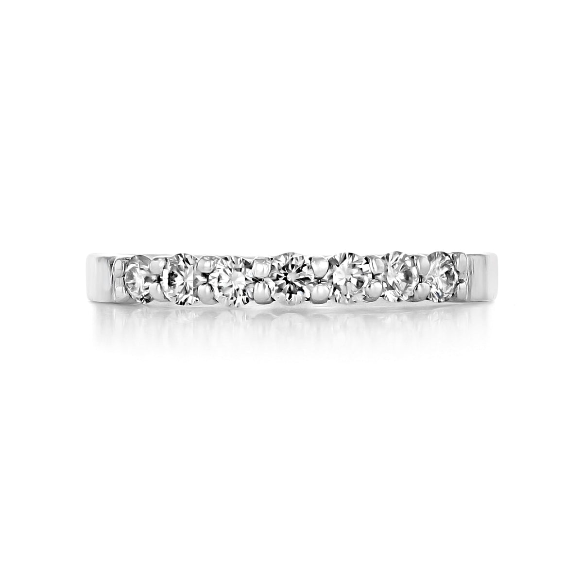Marabel prong-set diamond wedding band in platinum featuring a row of seven prong-set round diamonds.