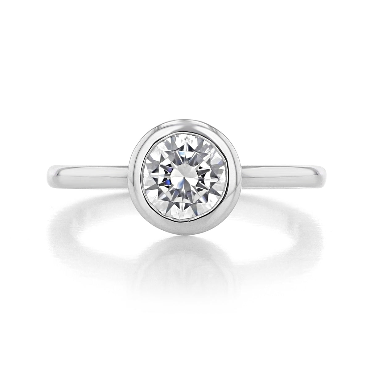 A Danhov Per Lei | Bezel Engagement Ring - LE100 featuring a round-cut diamond in a bezel solitaire setting on a polished metal band.