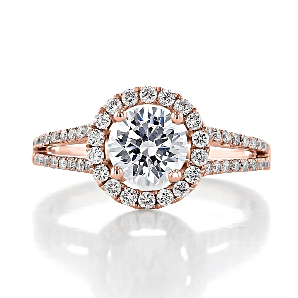 Habra | Round Halo Engagement Ring featuring a center diamond surrounded by a halo of micro-prong stones on a split-shank band.