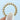 A gold RoyalT | Eternity Band - HT263765Y featuring a continuous row of round diamonds held by decorative prongs, held between a thumb and index finger.