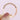 A 14k rose gold Coastal Crescent | Diamond Band - P104BFPK by Tacori with a scalloped, diamond-set band held between two fingers.