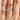 An Icing On The Ring Solitaire Proposal Ring | SO38 featuring a round-cut solitaire engagement ring on a 14k rose gold band worn on a finger.