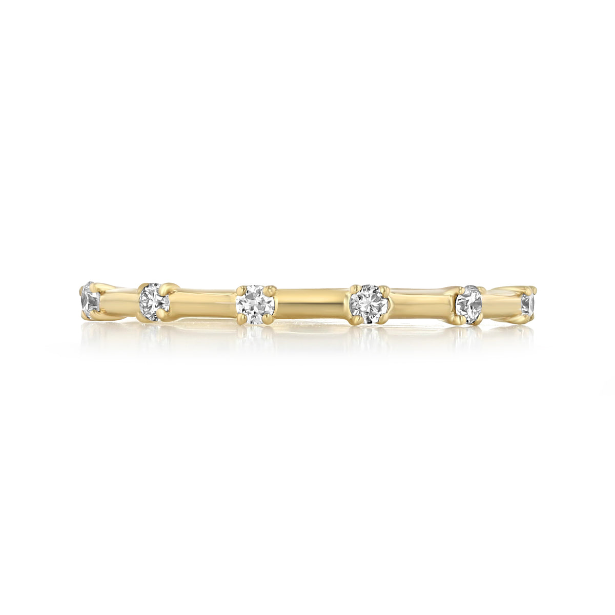 Mavis prong-set diamond wedding band in 14k yellow gold, featuring six round-cut diamonds in prong settings.