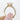 A hand holds a Makur Morganite Engagement Ring | R939-4, featuring a light pink oval-cut morganite and a pavé diamond band set in 14k yellow gold.