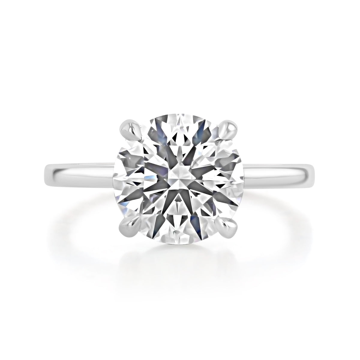 Hope | Round Solitaire Engagement Ring in 14k white gold, top view of a round center diamond in a four-prong setting.