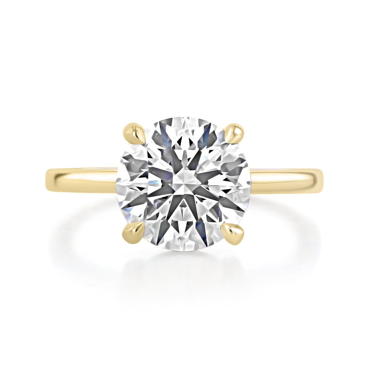 Hope | Round Solitaire Engagement Ring in 14k yellow gold, top view of a round center diamond in a four-prong setting.