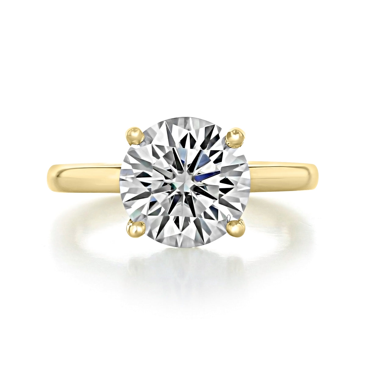Olympic round solitaire engagement ring with a hidden halo, featuring a yellow gold band and a four-prong setting.