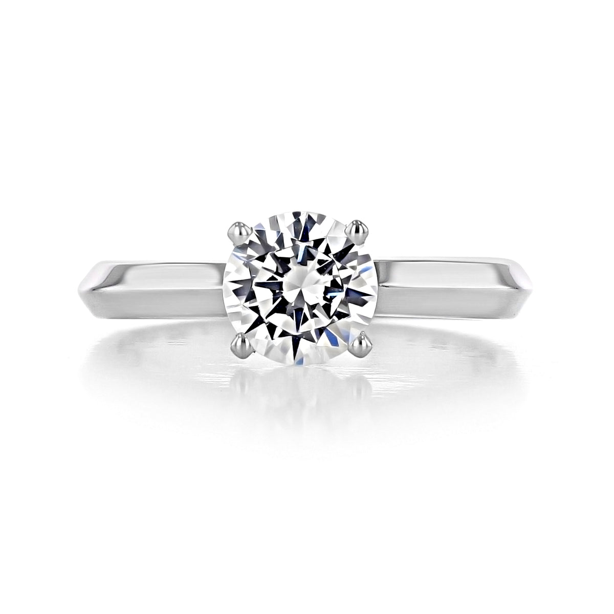 Elara | Round Solitaire Engagement Ring featuring a round diamond held by four prongs on a polished knife-edge band.