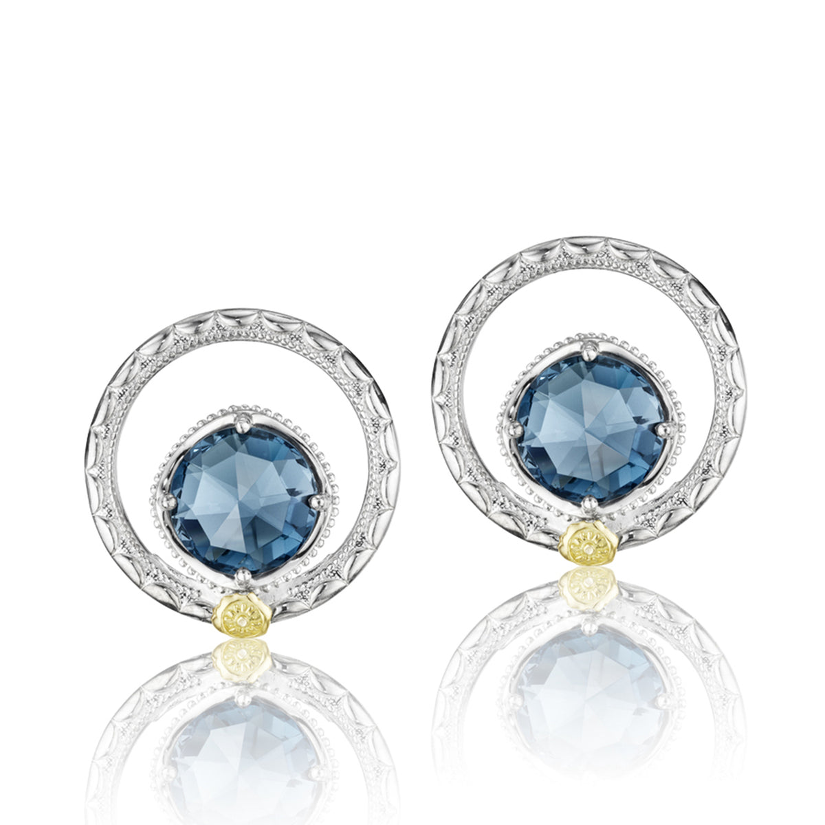 Tacori Gemma Bloom London Blue Topaz Fashion Earrings (SE14033) feature round, faceted London blue topaz stones centered in ornate silver frames with small yellow gold accents at the base of each.