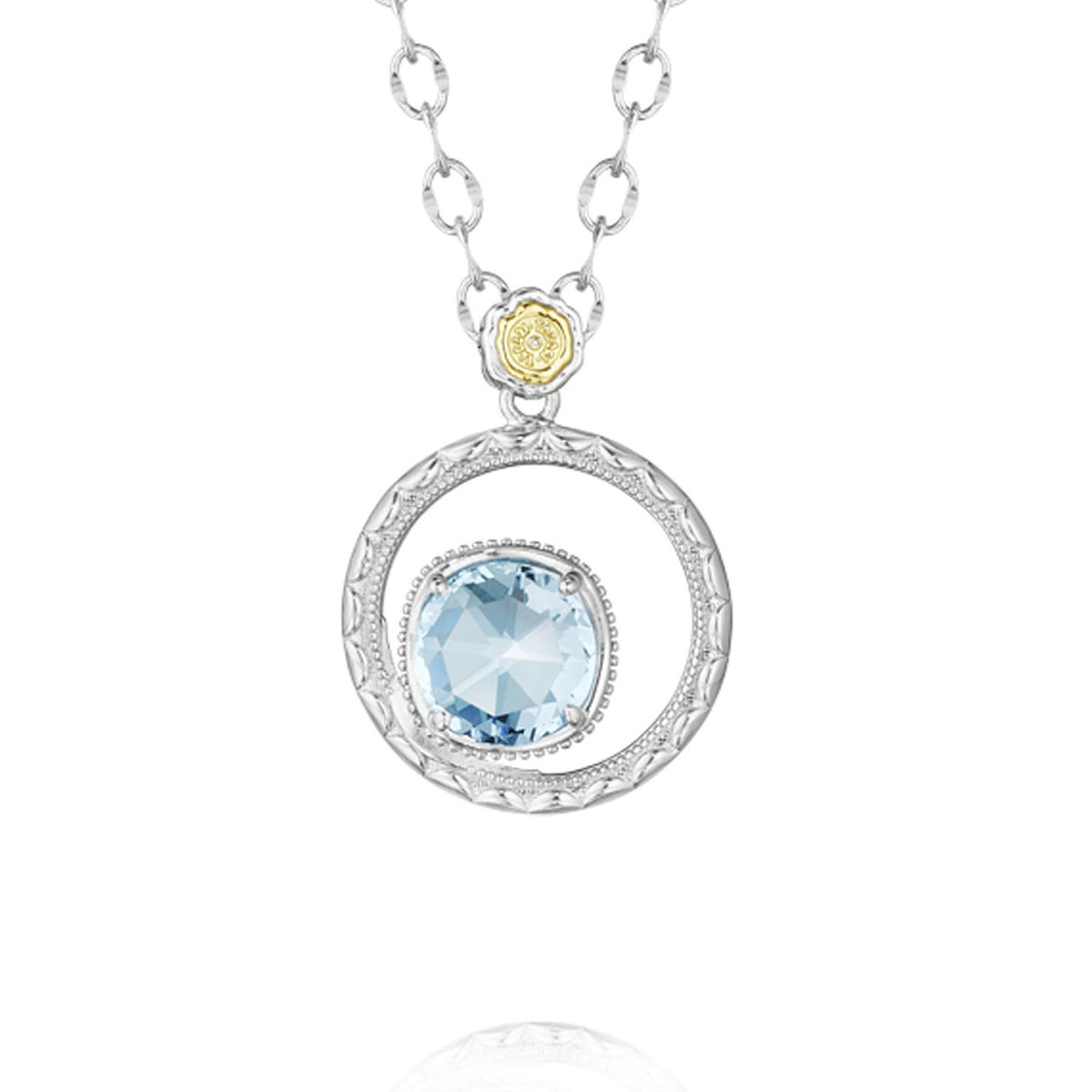 A Gemma Bloom Sky Blue Topaz Necklace | SN14002 featuring a circular silver pendant with a sky blue topaz, suspended from a chain by a small gold and silver flower-shaped bail.