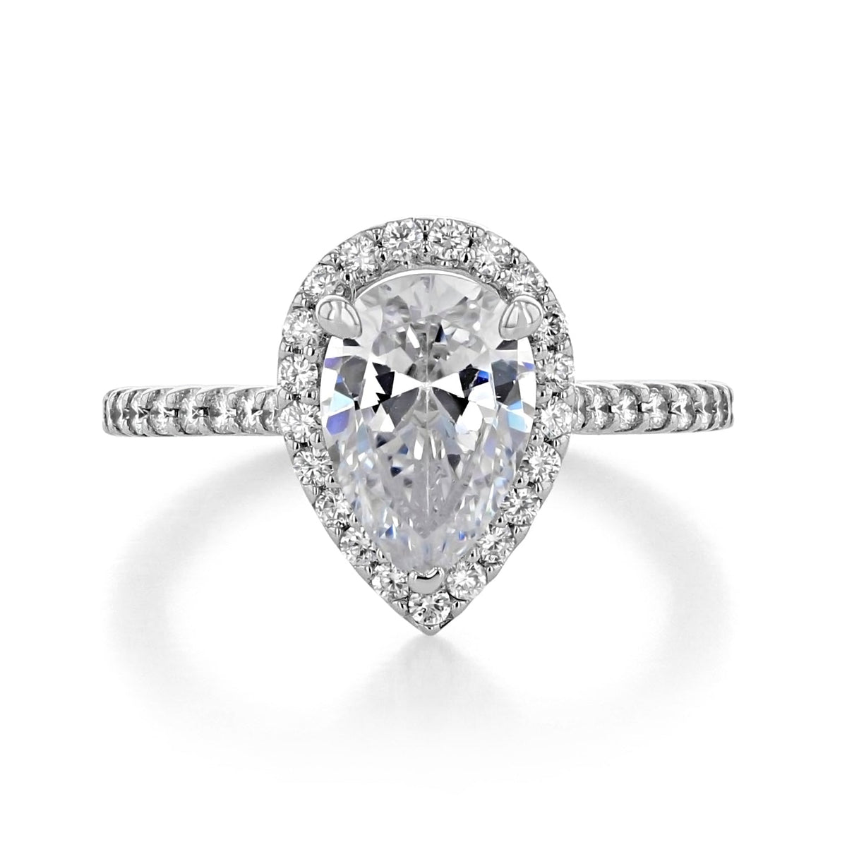 Pear-cut diamond engagement ring with a halo and pavé-set band.