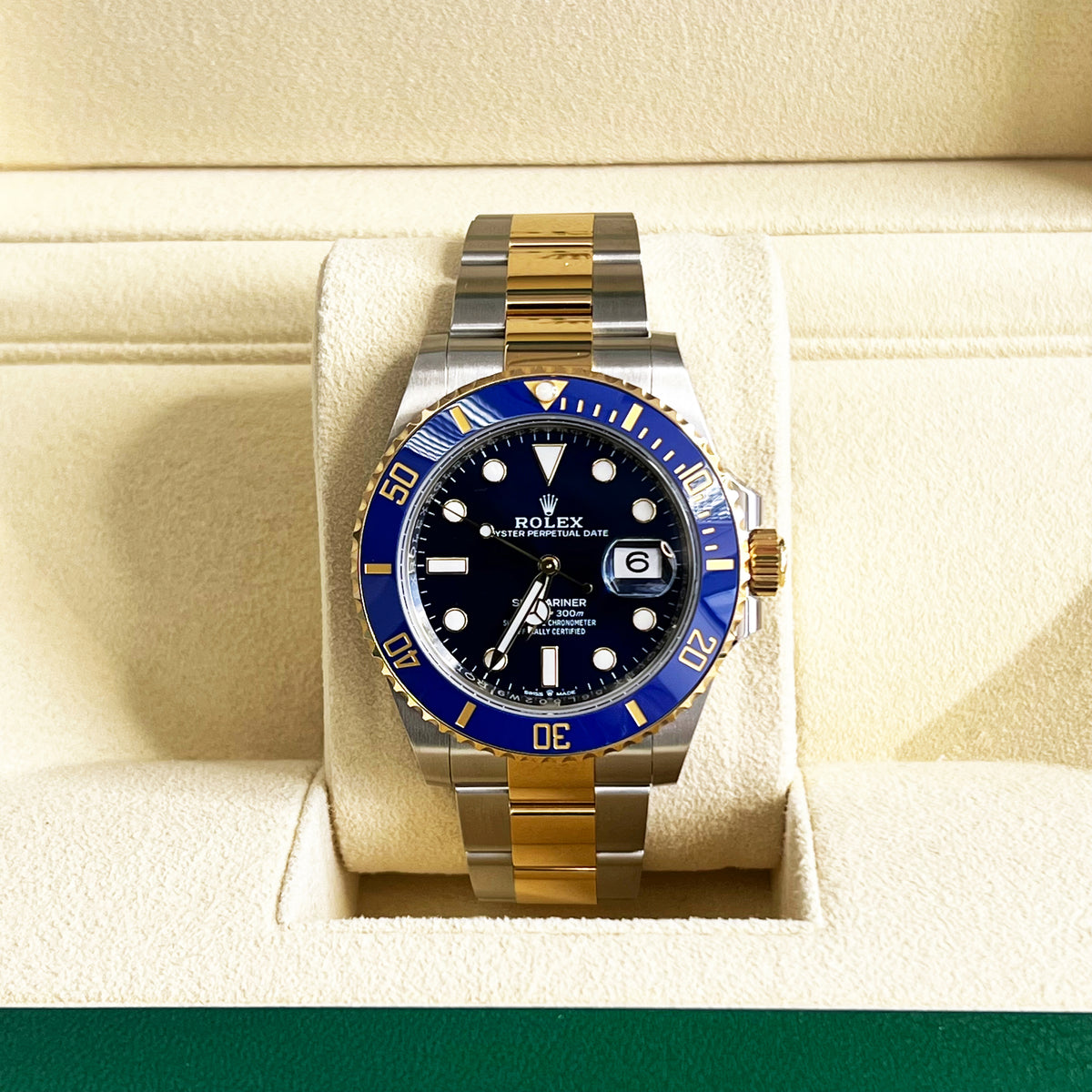 Rolex Submariner Date 41mm Blue Dial Watch | 126613LB in two-tone silver and 18k yellow gold with a blue ceramic rotating bezel, displayed in a cream-colored watch box.