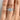 A Juliet Round Micro-Prong Engagement Ring featuring a round center diamond solitaire with a micro-prong pavé-set band worn on a finger.