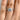 A finger wearing a Simply Tacori | Round Solitaire Engagement Ring - 267015RD75W featuring a round-cut solitaire diamond on a micro-prong diamond pavé band.