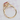 Champagne Sapphire Halo Engagement Ring | 2006291, a gold ring featuring an oval-cut reddish-orange gemstone with a diamond halo and diamonds set along the band.