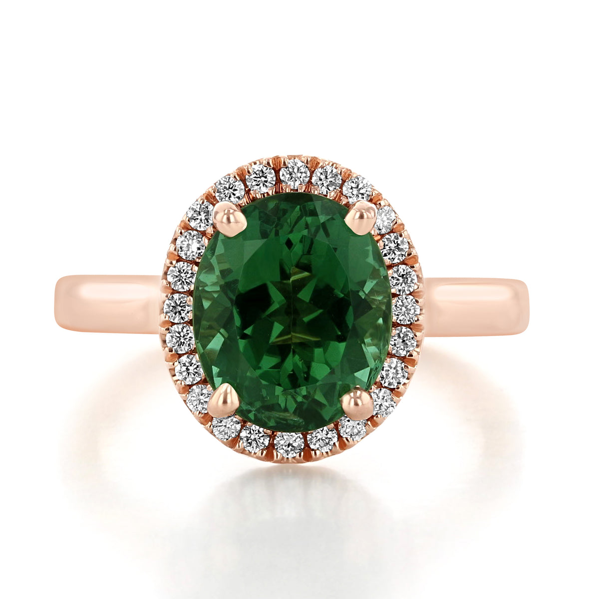 Green Tourmaline | Halo Engagement Ring featuring an oval-cut green tourmaline with a diamond halo on a rose gold band.