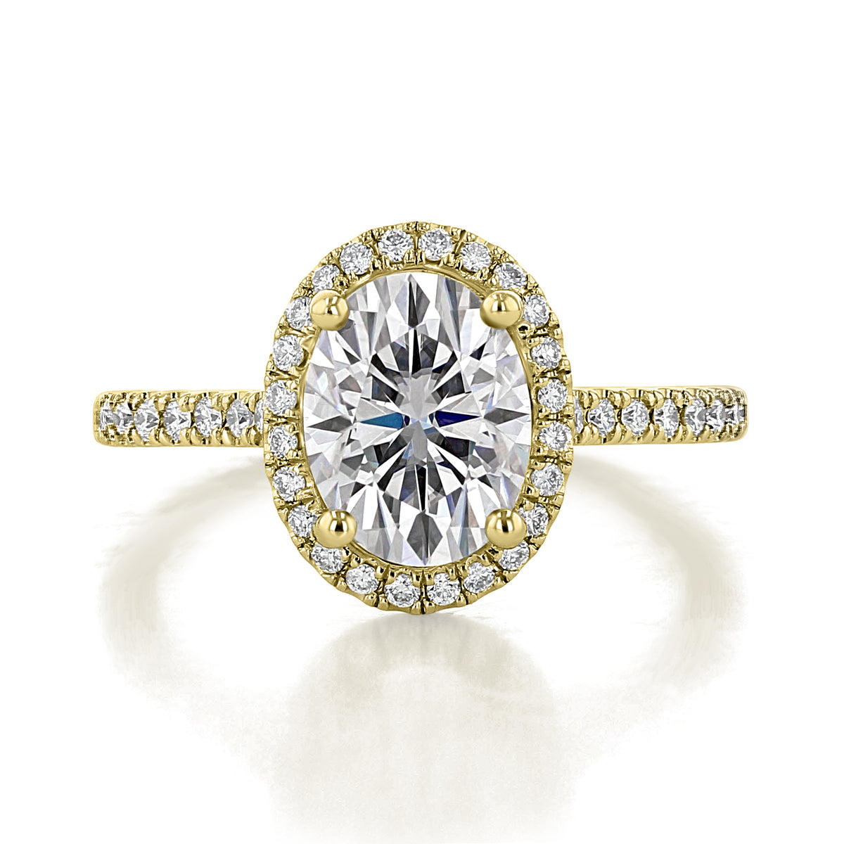 Daphne oval halo engagement ring by Icing On The Ring featuring a large center diamond on a thin 14k yellow gold band with pavé-set diamonds.