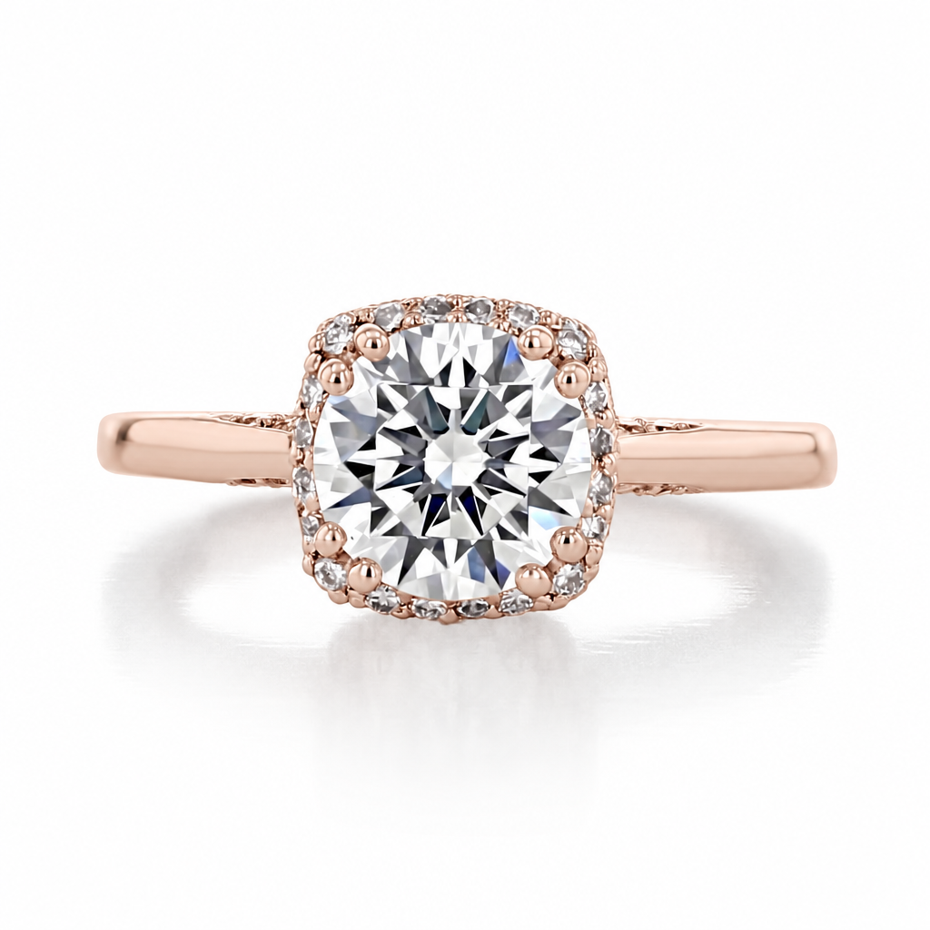 Rose gold engagement ring with a round center diamond in a cushion-shaped diamond halo