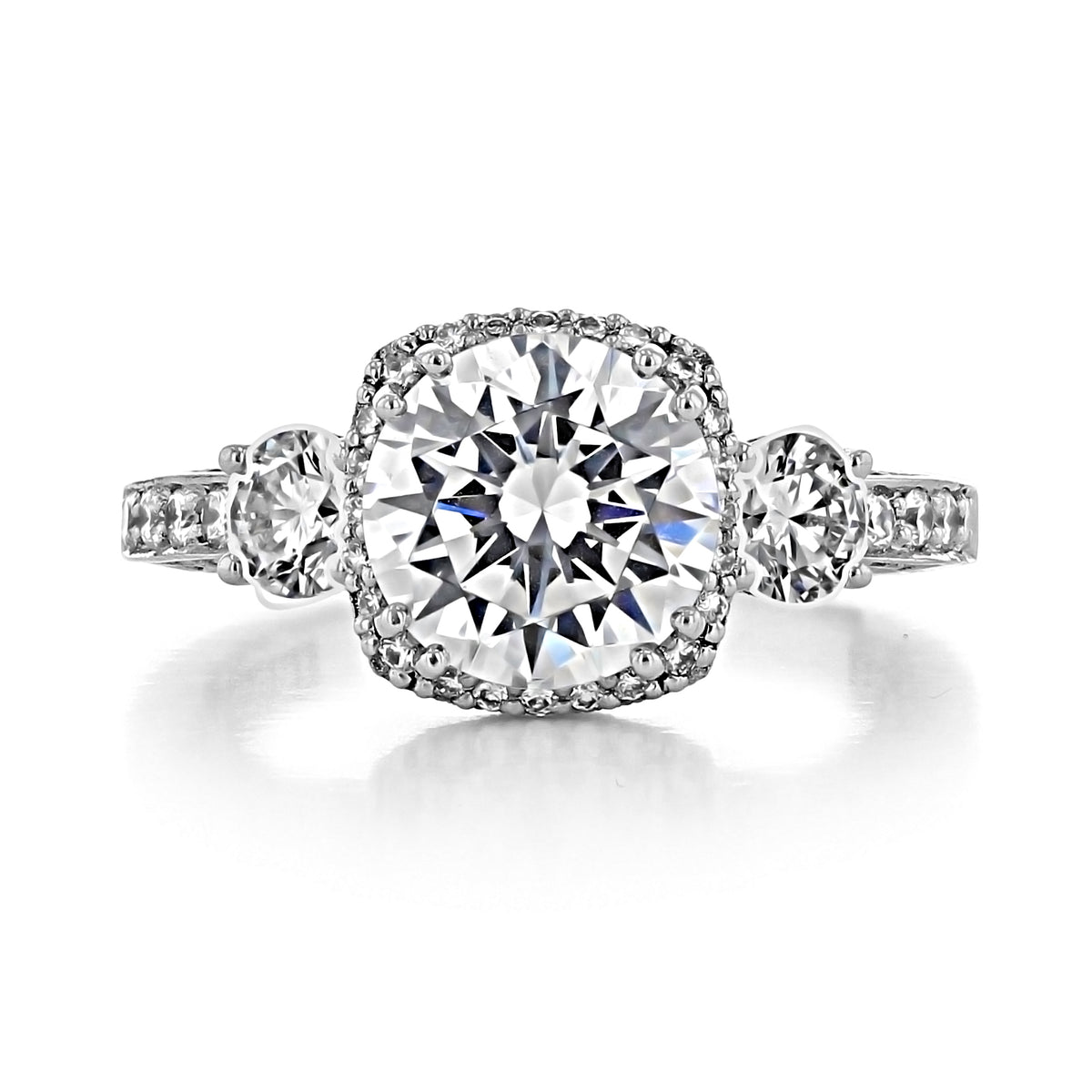 A Tacori Dantela | Round Bloom Engagement Ring - 2623RDLGPW featuring a three-stone design with a round center diamond framed by a diamond bloom, flanked by two smaller round diamonds on a pavé band.