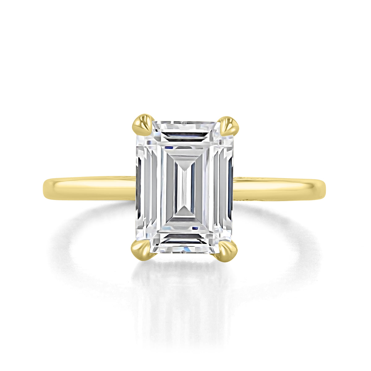 Simply Tacori Emerald Solitaire Engagement Ring 268815EC95X7Y, an emerald-cut solitaire engagement ring featuring a yellow gold band and a four-prong setting.