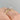 A Simply Tacori | Oval Solitaire Engagement Ring - 268822OV10X75WPK in rose gold with an oval diamond, a hidden halo of small diamonds, and decorative diamond accents on the band, worn on a finger.