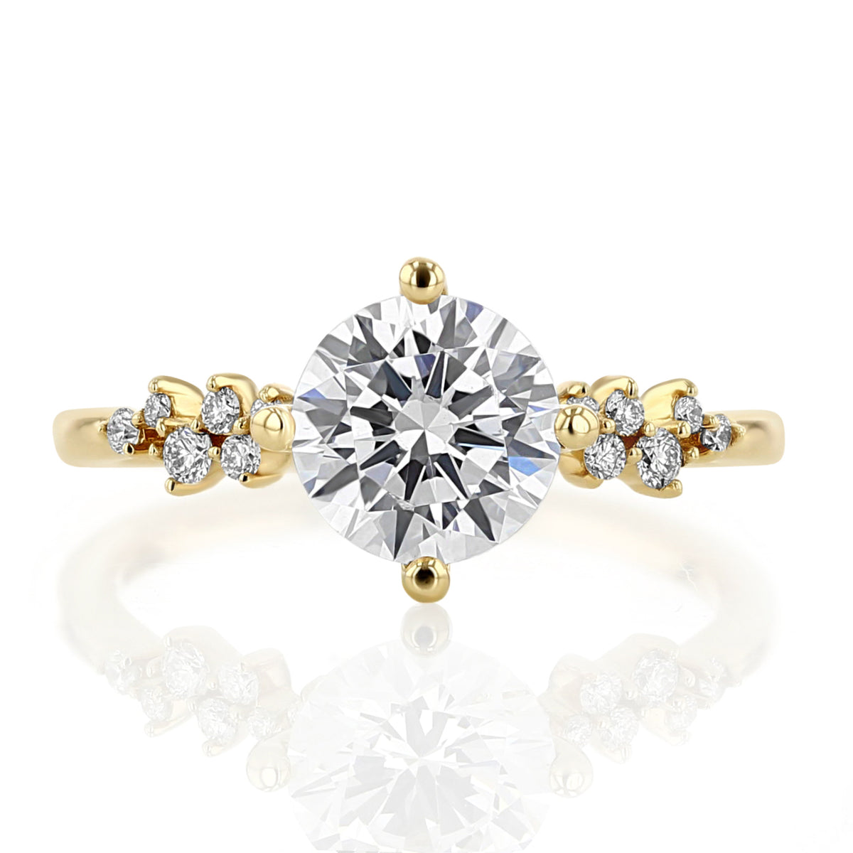 Iris Round Cluster Diamond Engagement Ring in 14k yellow gold featuring a round-cut diamond flanked by clusters of smaller diamonds.