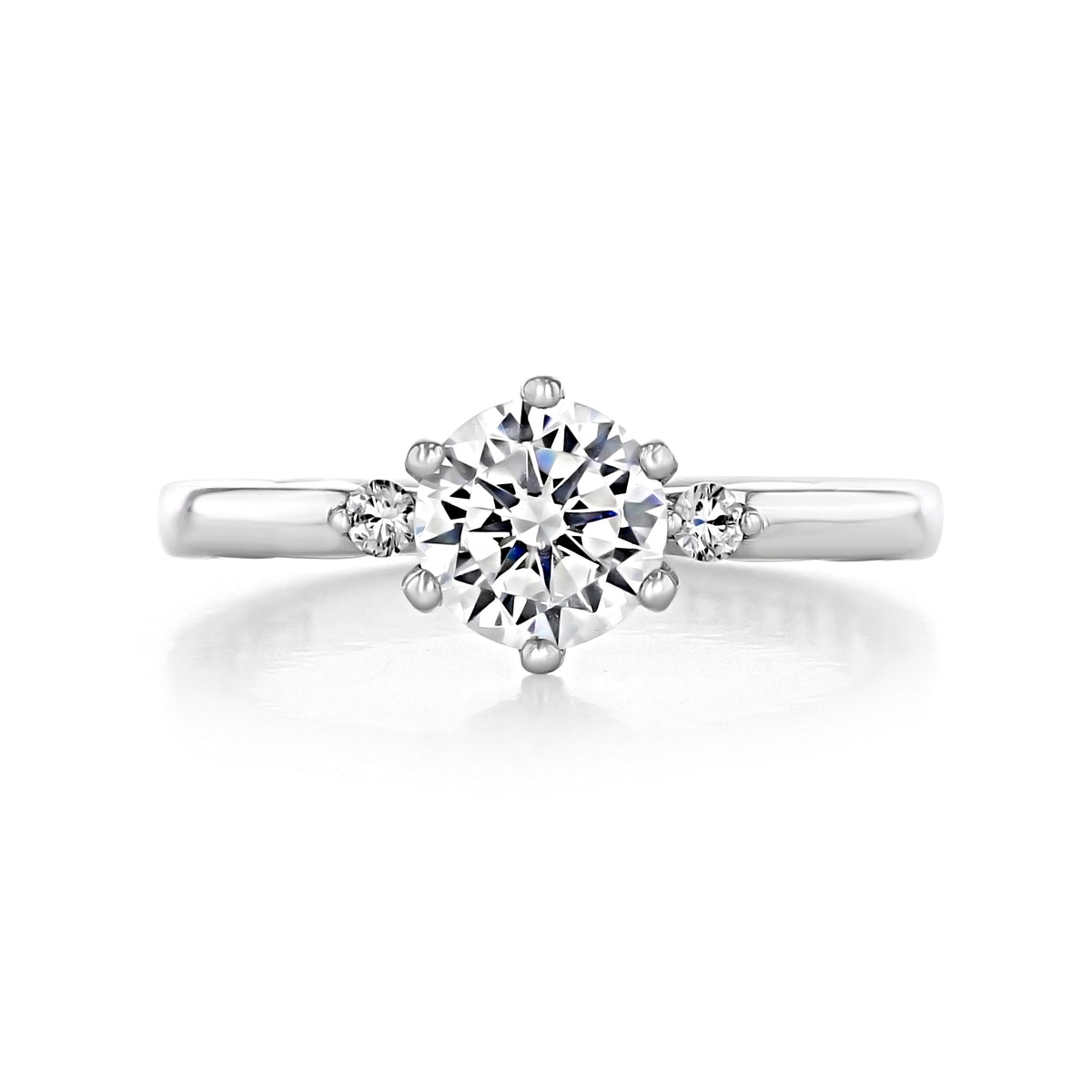 A silver Sculpted Crescent | Round Pavé Engagement Ring - 56-2RD65W featuring a six-prong, large round center diamond flanked by two smaller round diamonds on a smooth band.