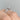 Simply Tacori | Round Solitaire Engagement Ring - 2678RD85W with a round diamond and diamond-encrusted prongs on a finger.