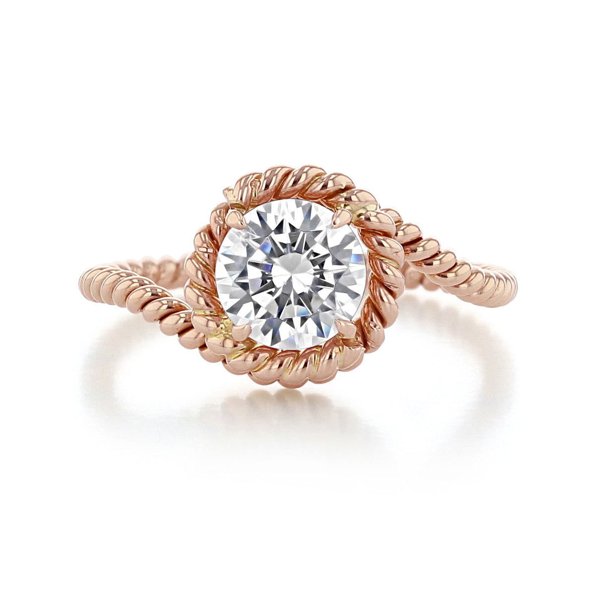 A round brilliant-cut diamond held in a rose gold Abbraccio | Swirl Engagement Ring - AE135 solitaire setting featuring a braided, rope-like swirl band.