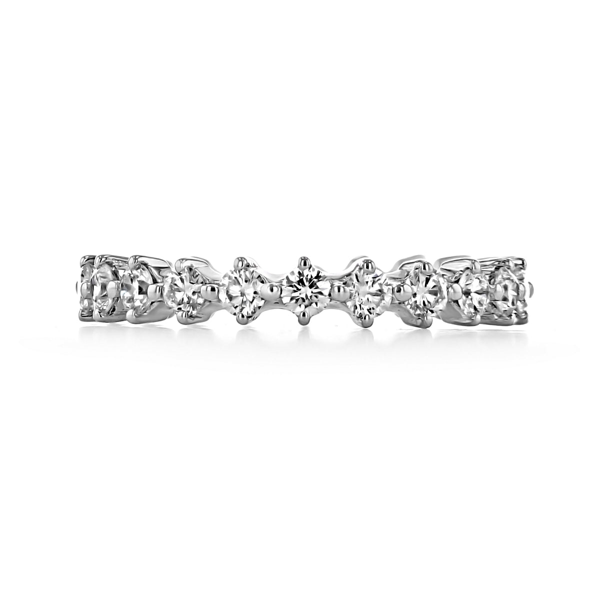 The Eden | Compass Prong-Set Diamond Wedding Band by Gabriel NY is a silver-tone band featuring a row of round diamonds held in a shared-prong setting.