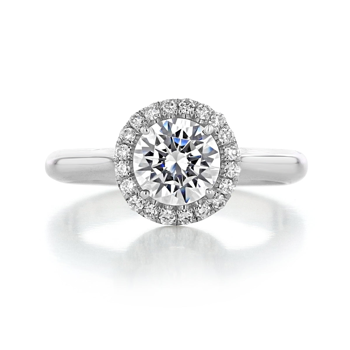 A Danhov Classico | Halo Engagement Ring - CL102 featuring a round-cut diamond in a halo setting on a smooth metal band.