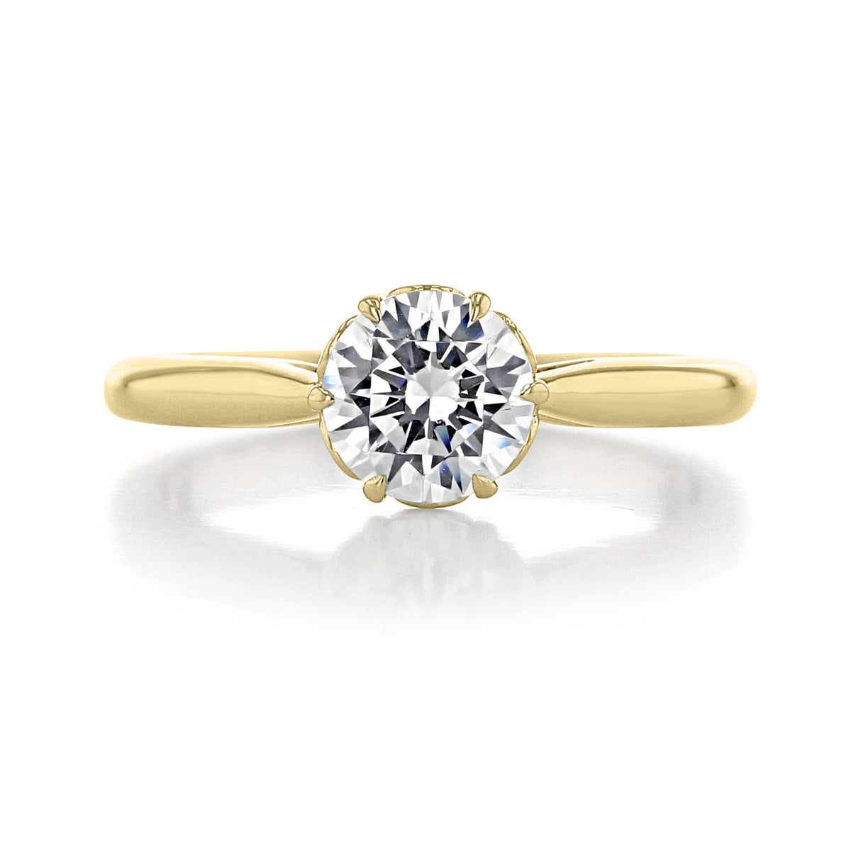 The Classico | 6-Prong Engagement Ring - CL105 is a round-cut diamond solitaire featuring a high-polished band and a six-prong yellow gold setting.