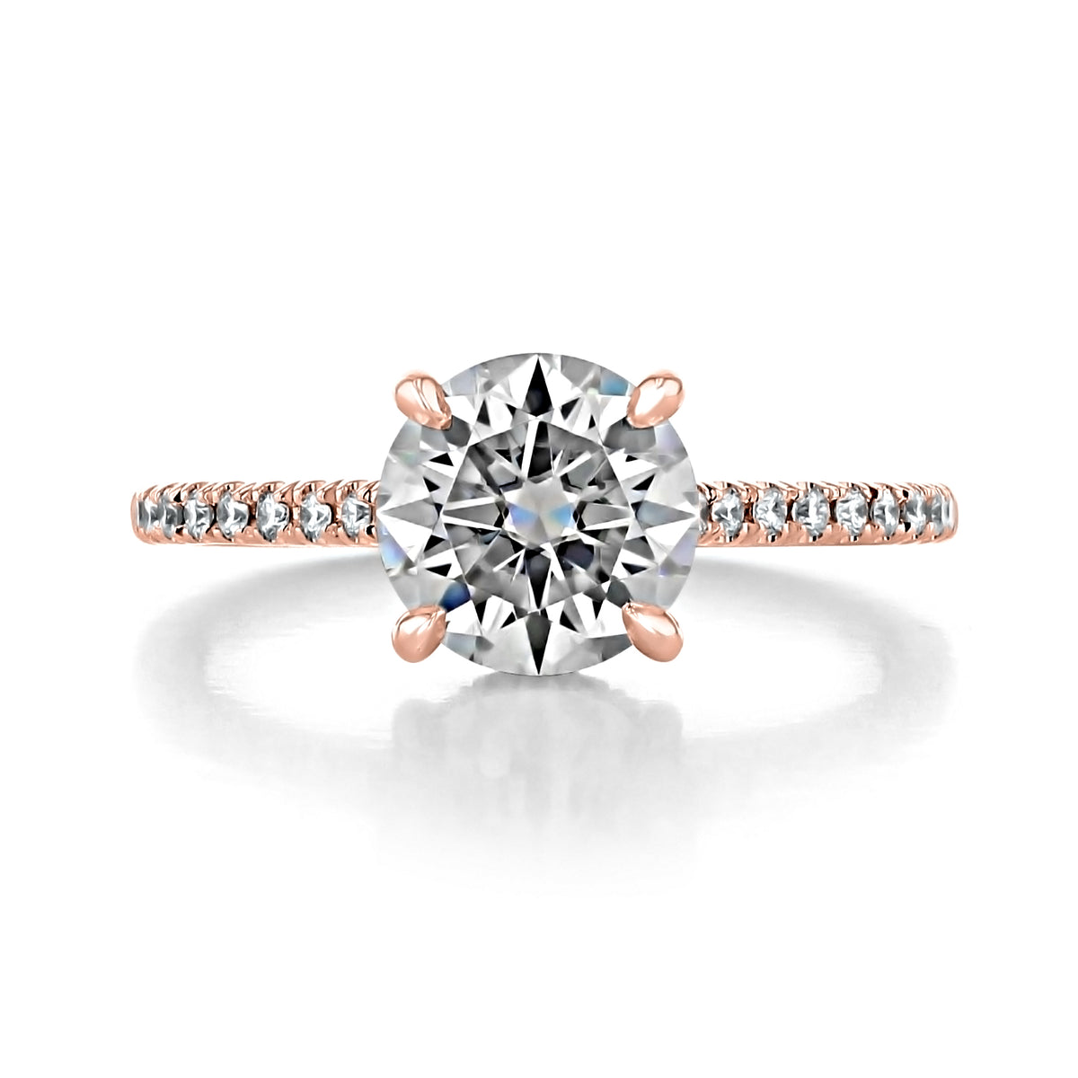 Delaney | Round Hidden Halo Engagement Ring featuring a round diamond solitaire on a rose gold band with pavé diamonds along the shank.
