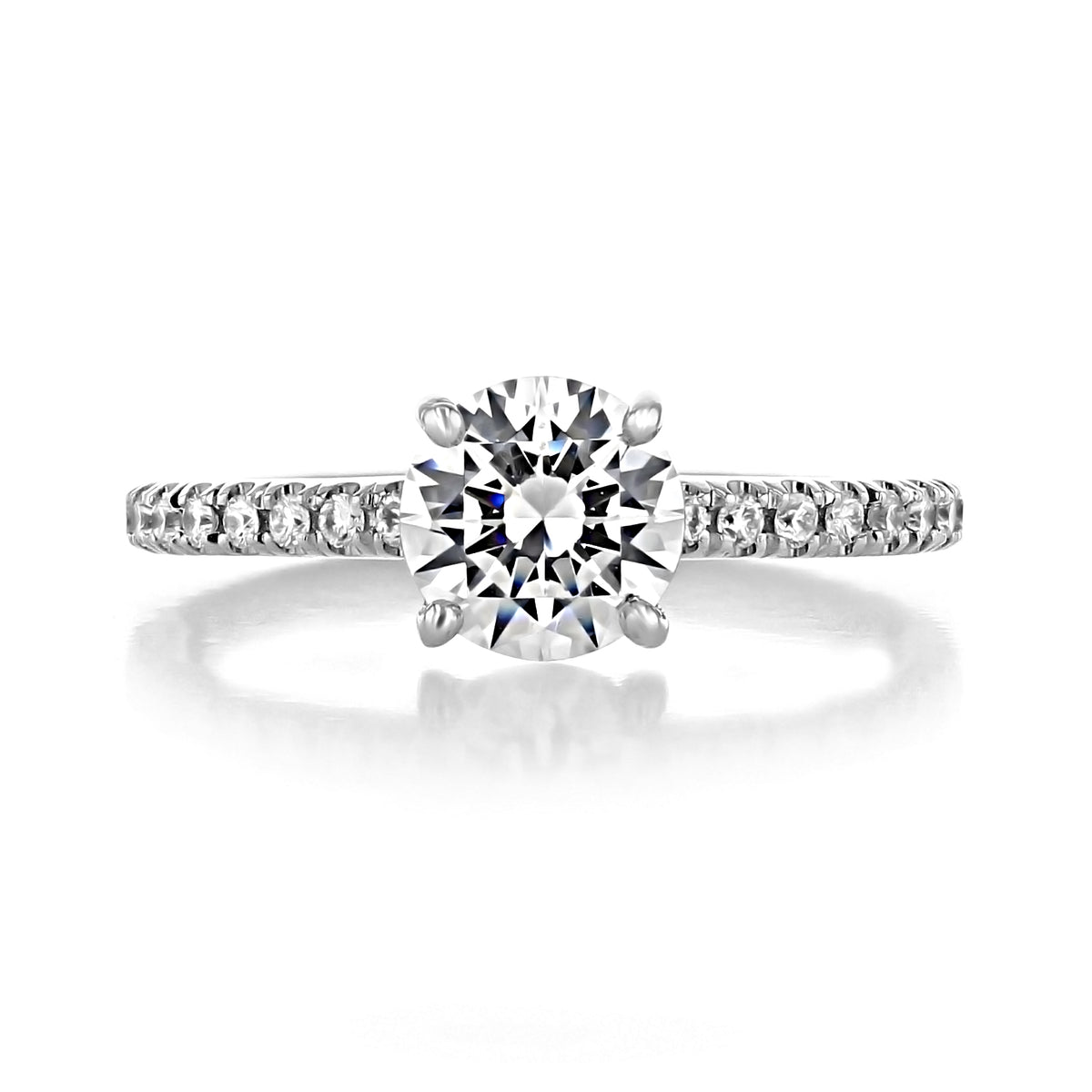 Carthay | Round Micro-Prong Engagement Ring featuring a round-cut diamond on a pavé-set band against a white background.