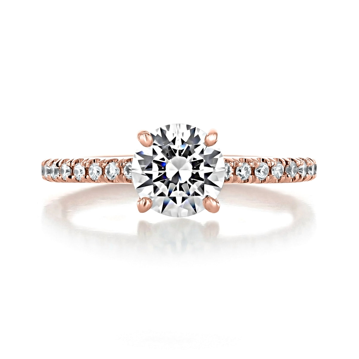 Carthay | Round Micro-Prong Engagement Ring featuring a 1.5 ct round-cut diamond solitaire on a rose gold band accented with small pavé-set stones.