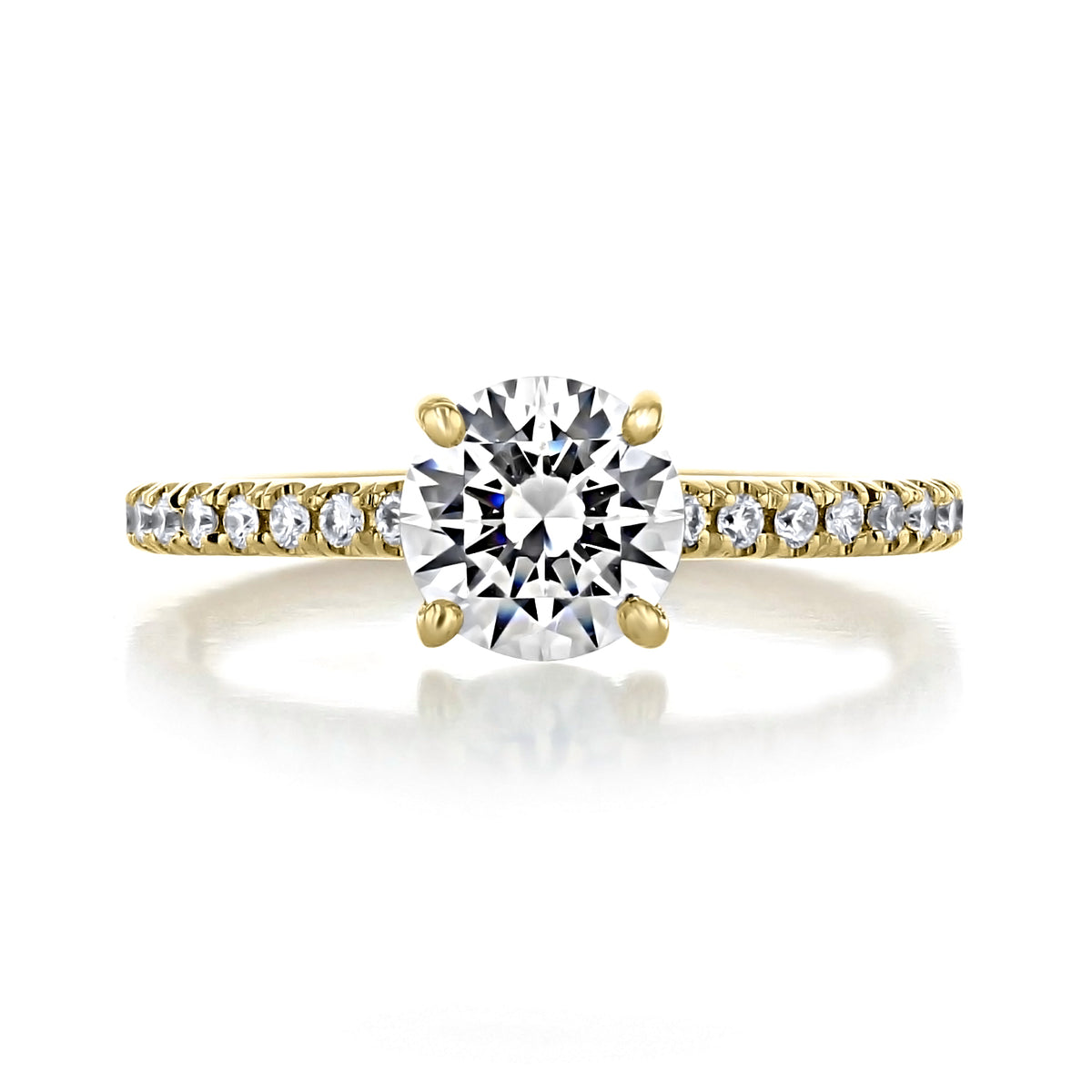Carthay | Round Micro-Prong Engagement Ring in gold featuring a 1.5 ct. diamond held by four micro-prong set diamonds on a band encrusted with smaller round accent stones.