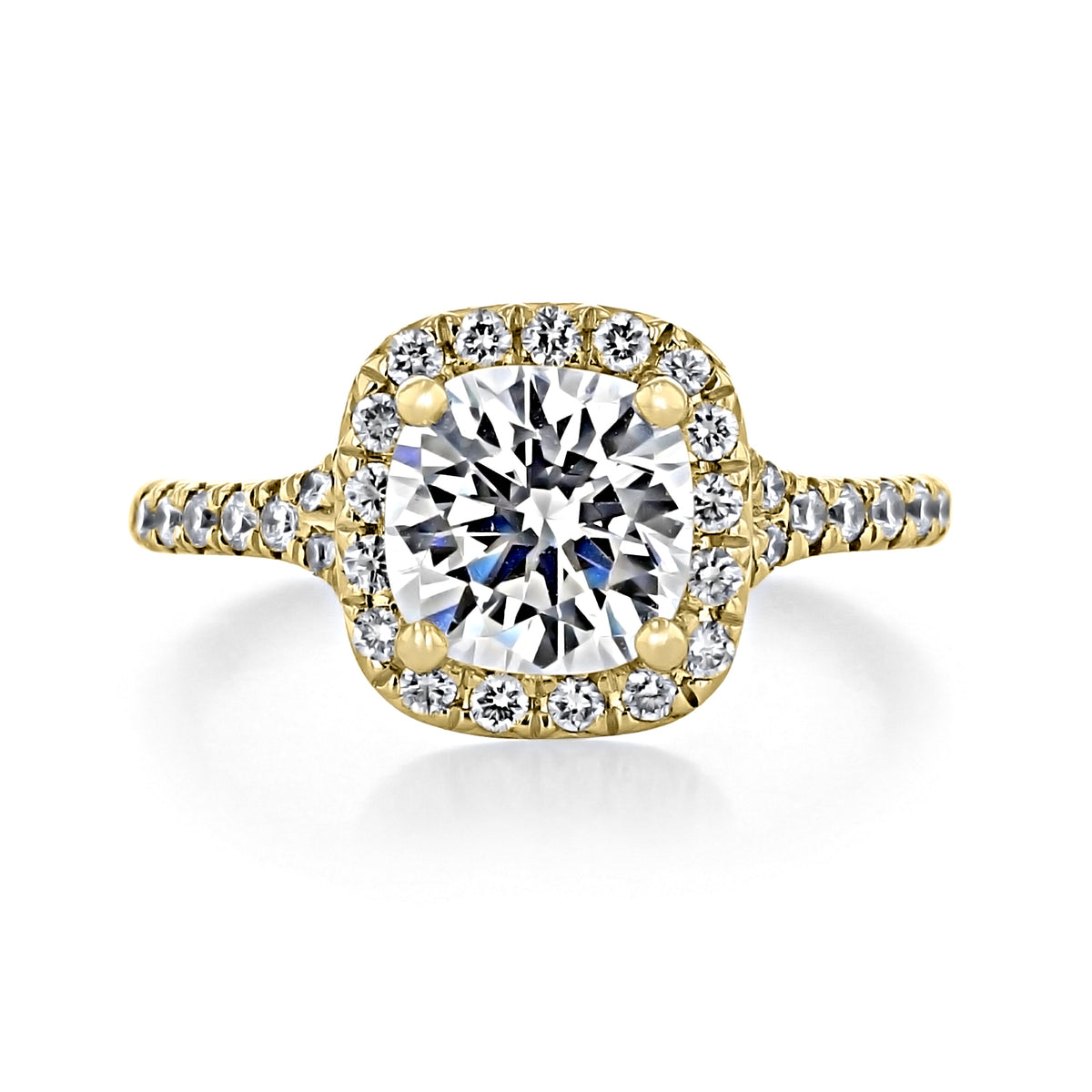 Sonoma | Round Halo Engagement Ring in gold, featuring a round-cut center diamond surrounded by a cushion-shaped halo of smaller diamonds, with additional stones set along the band.