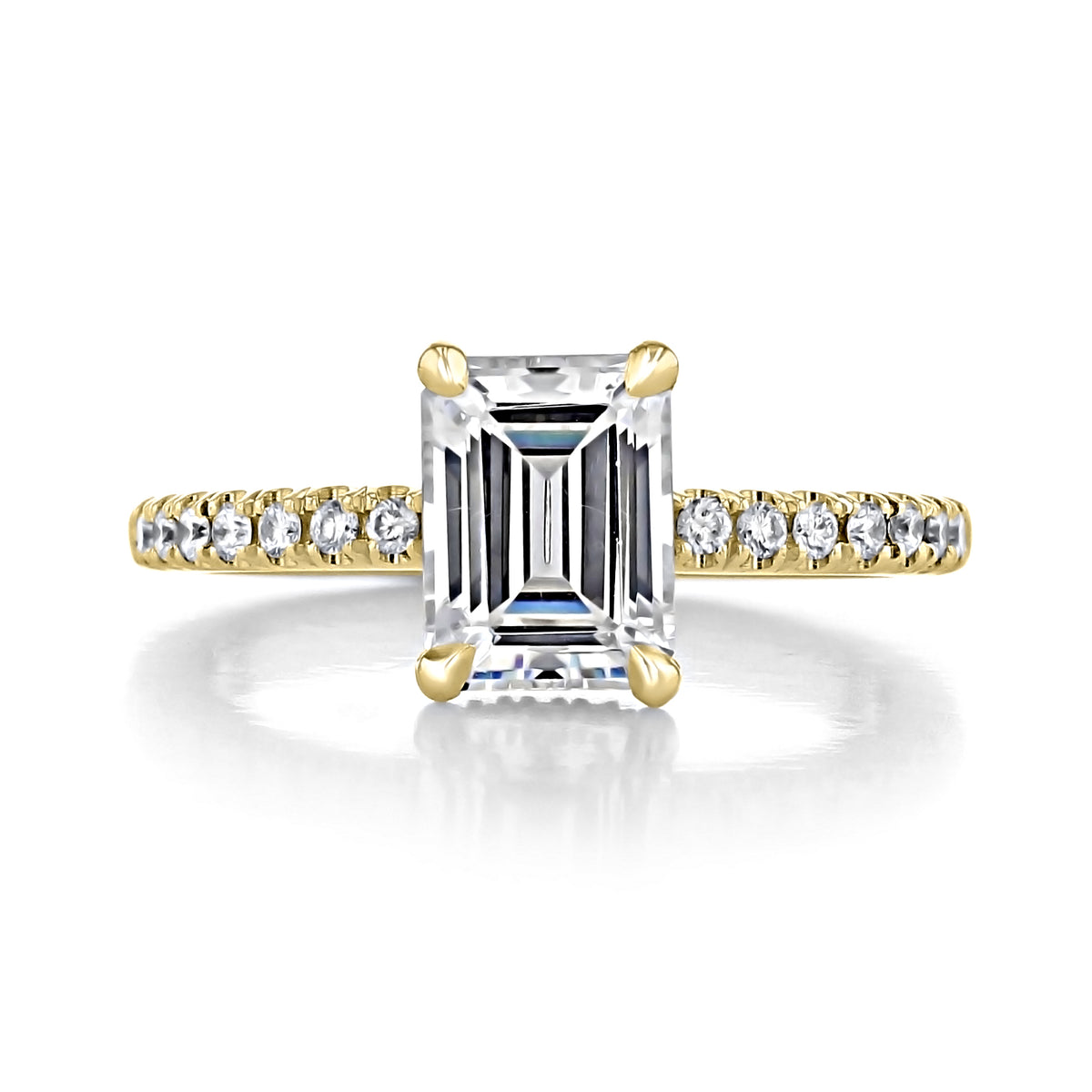 Kiara | Emerald Hidden Halo Engagement Ring in yellow gold featuring an emerald-cut center stone, a row of diamonds on each side, and a hidden halo.