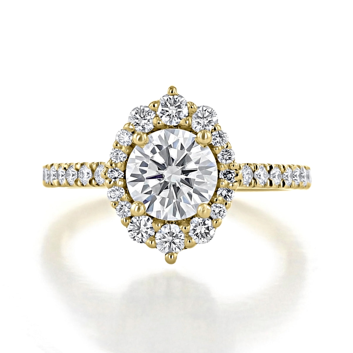 The Olvera | Round Unique Halo Engagement Ring features a round diamond with a unique scalloped halo of smaller stones on a micro-prong set pavé gold band.