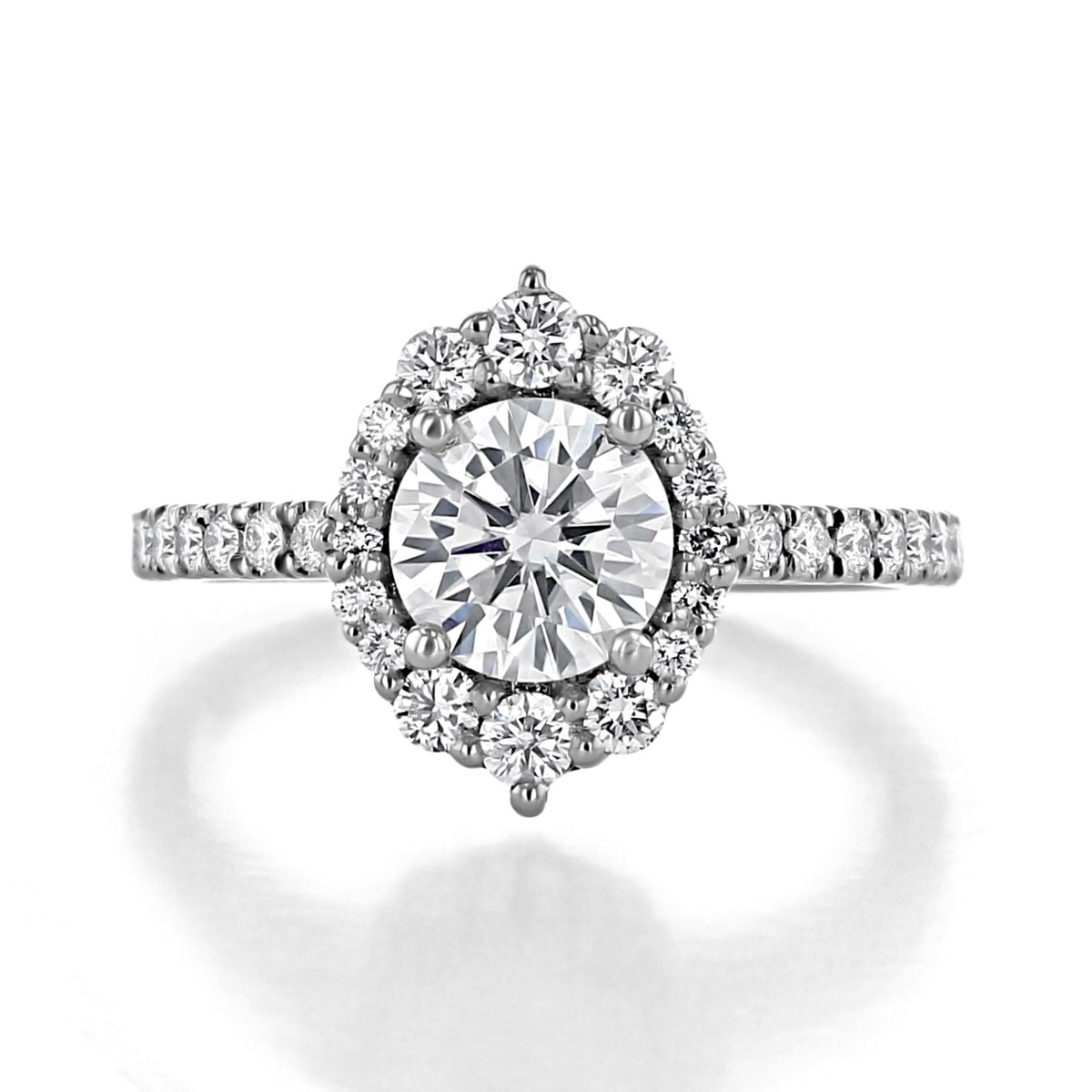 Olvera Round Unique Halo Engagement Ring with a round-cut diamond, a floral-shaped halo, and a micro-prong set diamond band.