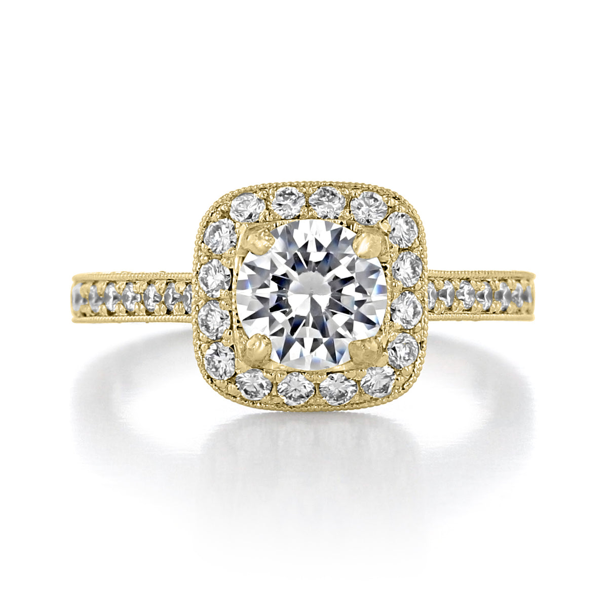 Granada | Round Halo Engraved Engagement Ring featuring a round center diamond, a square halo of small stones, and engraved metal detailing on the band.