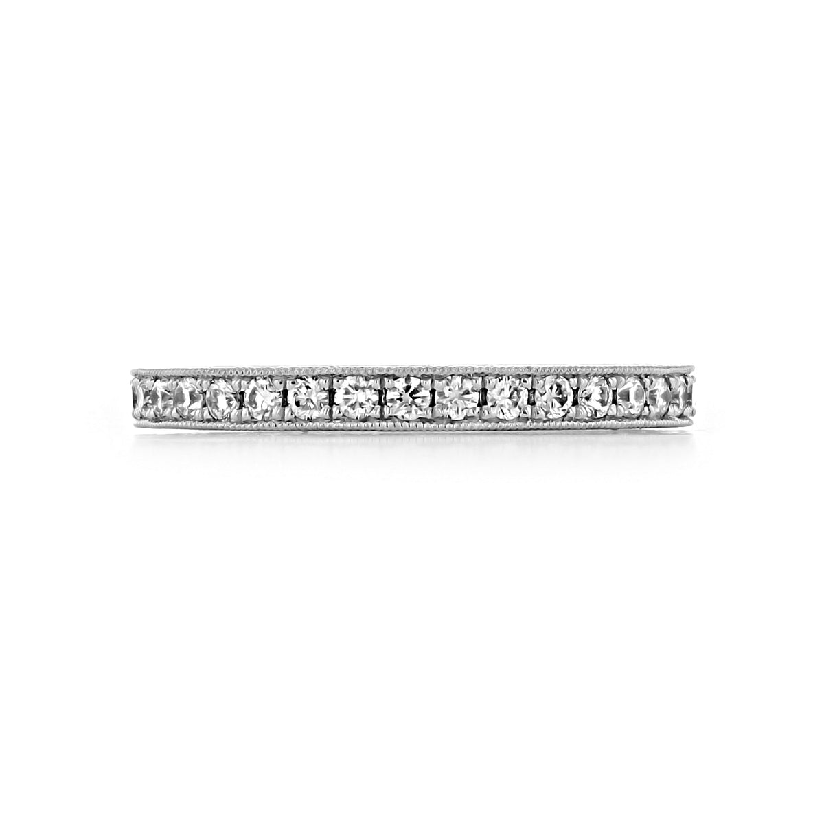 The Sabina 2.25mm Engraved Pavé-Set Diamond Wedding Band is a thin 14k white gold ring featuring a row of pavé-set diamonds with milgrain edges.