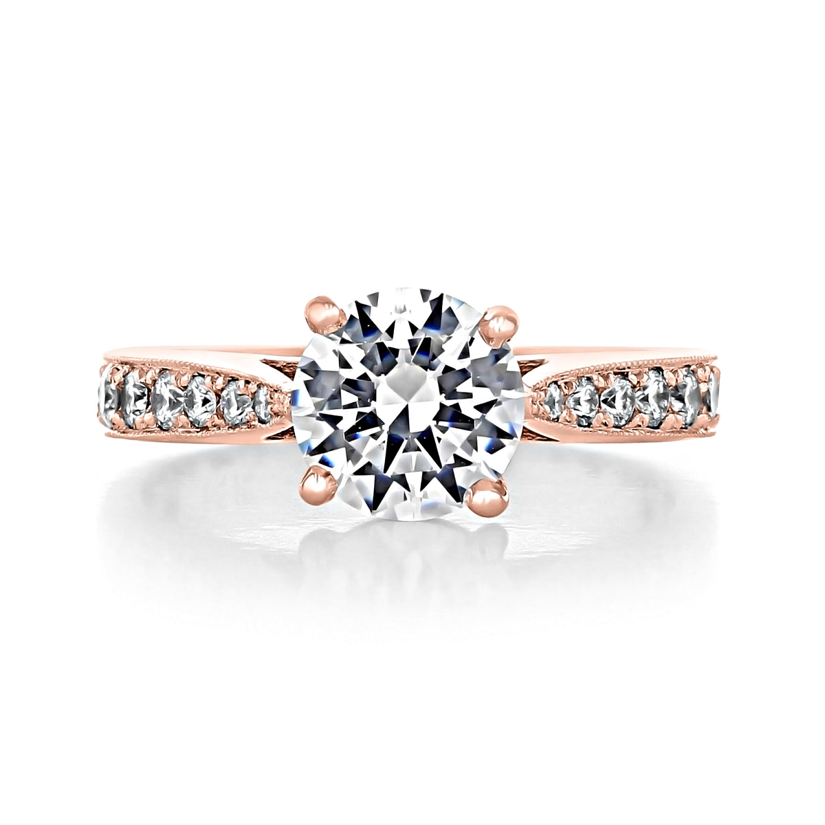 Skylar | Round Pavé Engagement Ring featuring a round-cut diamond on a rose gold band with pavé-set diamonds along the shoulders.