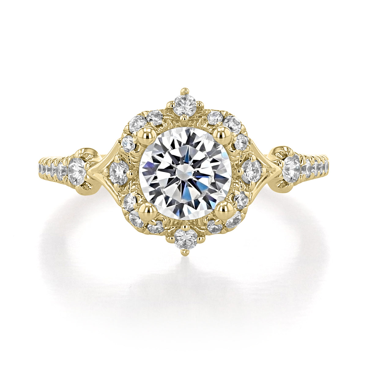 Veronique Halo Engagement Ring by Gabriel & Co. featuring an antique gold band with a round center stone, a hexagonal diamond halo, and diamond-accented split shanks.