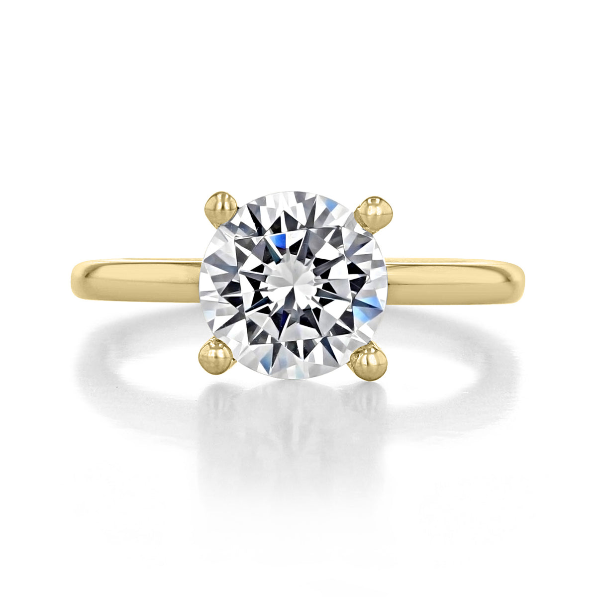 Paula | Solitaire Engagement Ring by Gabriel & Co. featuring a round brilliant-cut diamond set in a four-prong yellow gold band.